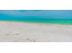 A view of the beach and ocean on a sunny day, with soft sand and turquoise water at 221 Howard Dr, Belleair Beach, FL 33786