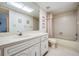 Bathroom with bathtub, toilet and vanity with a marble countertop at 3332 Scorecard Dr, New Port Richey, FL 34655