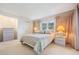 Bright bedroom with a queen-size bed and two nightstands at 3332 Scorecard Dr, New Port Richey, FL 34655
