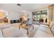 Bright living room with comfy seating, large windows, and access to a screened patio at 3332 Scorecard Dr, New Port Richey, FL 34655