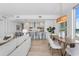 Open concept dining area with modern wood table and kitchen access at 5120 Marina Way # 8805, Tampa, FL 33611