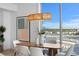 Modern dining room with wood table and stunning city views at 5120 Marina Way # 8805, Tampa, FL 33611