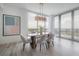 Elegant dining room with hardwood floors, large windows, and a modern chandelier at 5120 Marina Way # 8805, Tampa, FL 33611