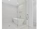 Elegant bathroom featuring a soaking tub, glass enclosure, and modern tile at 5120 Marina Way # 8805, Tampa, FL 33611