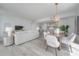 Open concept dining area with modern wooden table and chairs, adjacent to kitchen at 5120 Marina Way # 8805, Tampa, FL 33611