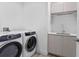 Laundry room with washer, dryer, and built-in cabinets at 5120 Marina Way # 8805, Tampa, FL 33611