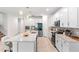 Modern kitchen with white cabinets, stainless steel appliances, and a large center island at 6248 Bradford Woods Dr, Zephyrhills, FL 33542
