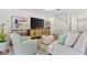 Open-concept living area with tiled floors, neutral tones, and modern furnishings at 6248 Bradford Woods Dr, Zephyrhills, FL 33542