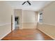 Spacious bedroom with wood-look floors and view of kitchen at 10906 Holly Cone Dr, Riverview, FL 33569