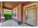 Covered front porch with tile flooring, window, and exterior door at 10906 Holly Cone Dr, Riverview, FL 33569