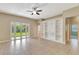 Spacious Gathering room with built-in shelving and sliding glass doors to backyard at 10906 Holly Cone Dr, Riverview, FL 33569