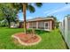 Landscaped backyard with large grassy area and privacy fence at 10906 Holly Cone Dr, Riverview, FL 33569