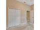 Bedroom with double door closet and access to hallway at 10906 Holly Cone Dr, Riverview, FL 33569