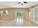 Gathering room with tile floors and access to the backyard at 10906 Holly Cone Dr, Riverview, FL 33569
