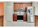 Kitchen with stainless steel appliances and wood cabinets at 10906 Holly Cone Dr, Riverview, FL 33569
