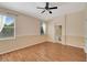 Bright bedroom with wood-look floors and access to bathroom at 10906 Holly Cone Dr, Riverview, FL 33569