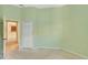 Bedroom with light green walls and access to kitchen at 10906 Holly Cone Dr, Riverview, FL 33569