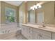Bathroom boasts a soaking tub, double vanity, and ample storage at 10906 Holly Cone Dr, Riverview, FL 33569