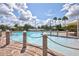 Resort-style pool with palm trees and brick patio at 10906 Holly Cone Dr, Riverview, FL 33569