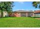 Back exterior view showing a screened porch and large yard at 10906 Holly Cone Dr, Riverview, FL 33569