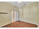 Bright bedroom with wood-look floors and an open door to another room at 10906 Holly Cone Dr, Riverview, FL 33569