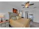 King-size bed in a well-lit bedroom with ensuite access at 13333 Gershwin Ln, Port Charlotte, FL 33981