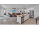 Open concept kitchen with large island and stainless steel appliances at 13333 Gershwin Ln, Port Charlotte, FL 33981