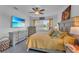 Primary bedroom with king-size bed, TV, and plenty of light at 13333 Gershwin Ln, Port Charlotte, FL 33981