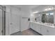 Double vanity bathroom with a large mirror and walk-in shower at 13333 Gershwin Ln, Port Charlotte, FL 33981