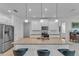 Modern kitchen with white cabinets, granite countertops, and stainless steel appliances at 13333 Gershwin Ln, Port Charlotte, FL 33981