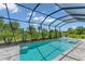 Refreshing pool with screened enclosure, offering a private oasis at 13333 Gershwin Ln, Port Charlotte, FL 33981