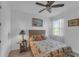 Bright bedroom featuring a full bed, nightstand, and ceiling fan at 13333 Gershwin Ln, Port Charlotte, FL 33981
