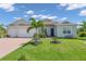 Beautiful two-car garage home with a well-manicured lawn at 13333 Gershwin Ln, Port Charlotte, FL 33981
