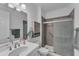 Simple bathroom with single vanity, shower, and linen cabinet at 13333 Gershwin Ln, Port Charlotte, FL 33981