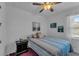 Cozy bedroom with striped bedding and a dark wood nightstand at 13333 Gershwin Ln, Port Charlotte, FL 33981