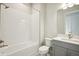 Modern bathroom with soaking tub, gray vanity, and tile shower at 10324 Longmeadow Ave, Parrish, FL 34219
