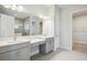Double vanity bathroom with gray cabinets and quartz countertops at 10324 Longmeadow Ave, Parrish, FL 34219