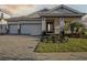 Beautiful single-story home featuring a brick paved driveway and two-car garage, and well-kept landscaping at 10324 Longmeadow Ave, Parrish, FL 34219