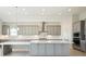 Modern kitchen with gray cabinets, white quartz countertops and large island at 10324 Longmeadow Ave, Parrish, FL 34219
