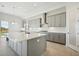 Island kitchen with stainless steel appliances and white quartz countertops at 10324 Longmeadow Ave, Parrish, FL 34219