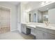 Double vanity bathroom with gray cabinets and quartz countertops at 10426 Longmeadow Ave, Parrish, FL 34219