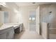 Modern bathroom with double vanity, quartz countertops, and a walk-in shower at 10426 Longmeadow Ave, Parrish, FL 34219