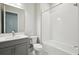 Modern bathroom with gray vanity and bathtub at 10426 Longmeadow Ave, Parrish, FL 34219