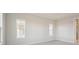 Well-lit bedroom featuring neutral wall tones and carpet flooring at 10426 Longmeadow Ave, Parrish, FL 34219