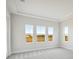 Bright bedroom with three large windows and plush carpeting at 10426 Longmeadow Ave, Parrish, FL 34219