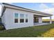 Exterior view of home with green lawn and multiple windows allowing for ample natural light at 10426 Longmeadow Ave, Parrish, FL 34219