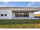 House exterior showcasing a covered patio and grassy yard at 10426 Longmeadow Ave, Parrish, FL 34219