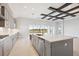 Gourmet kitchen boasts expansive island, stainless steel appliances, and ample cabinetry at 10426 Longmeadow Ave, Parrish, FL 34219