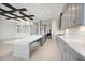 Modern kitchen with gray cabinets and a large quartz island at 10426 Longmeadow Ave, Parrish, FL 34219