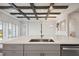 Modern kitchen island with quartz countertops and stainless steel sink at 10426 Longmeadow Ave, Parrish, FL 34219